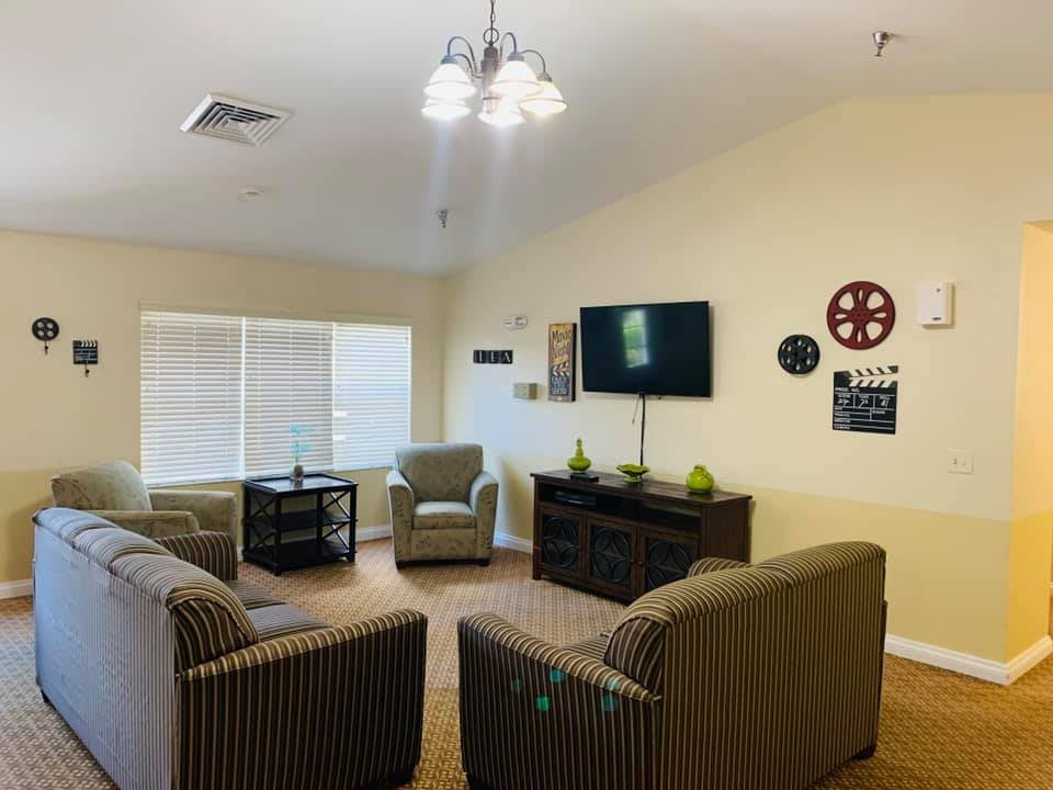 Cozy living room area with comfortable chairs, a television, and stylish decor.