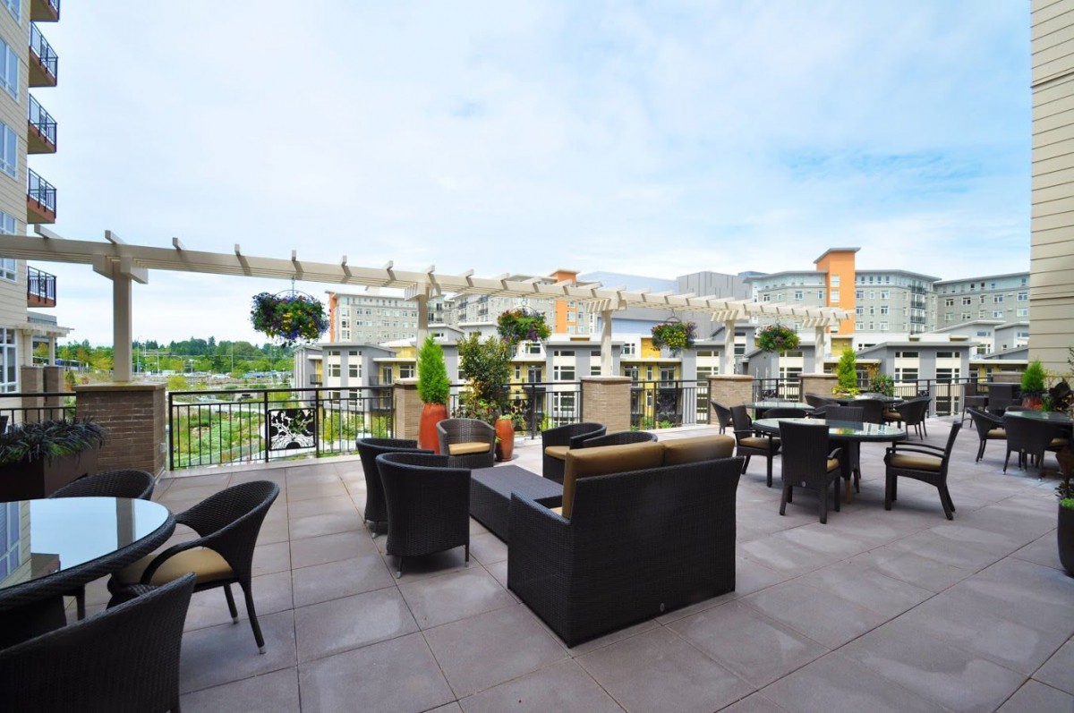 A stylish rooftop terrace with outdoor seating and a scenic city view.