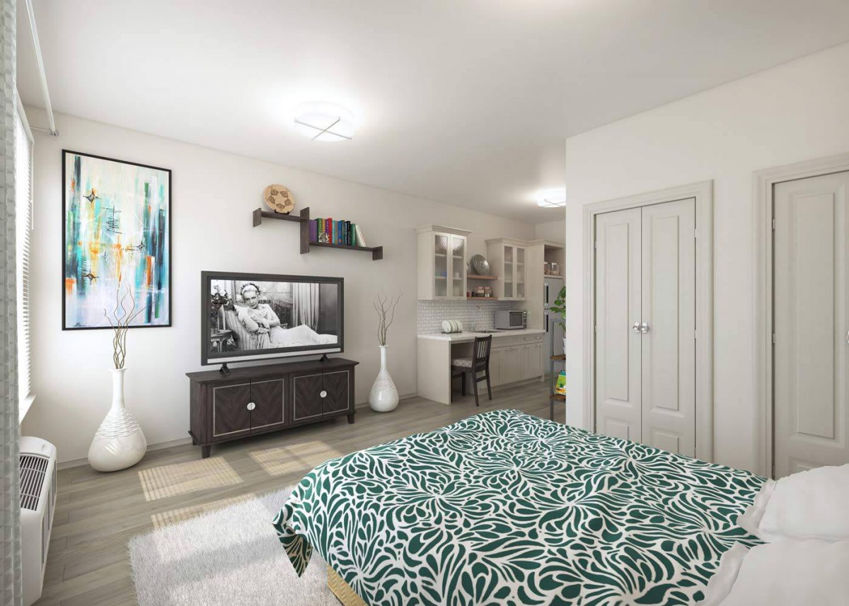 A modern bedroom with stylish decor, featuring a bed with patterned bedding, a television, and a workspace.