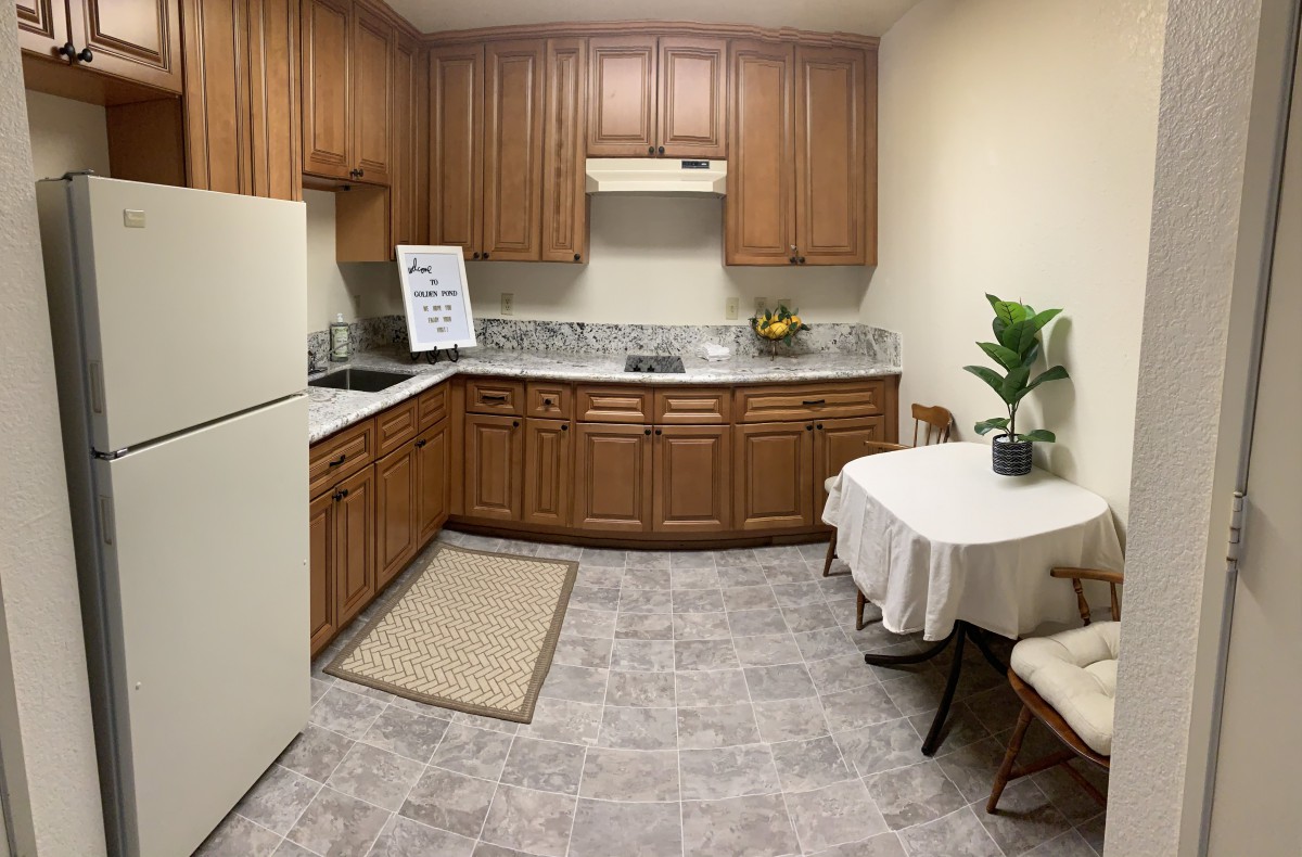 Cozy kitchen with wooden cabinets and a small dining area.