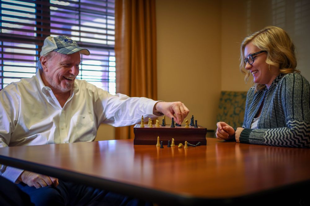 Two people enjoying a game of chess indoors.