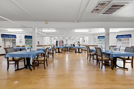 A spacious dining area with neatly arranged tables and chairs.