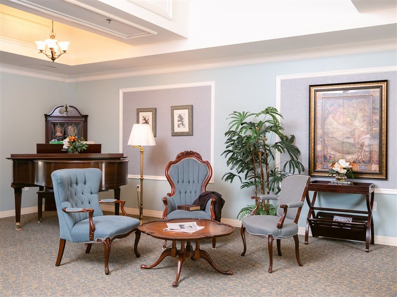 A cozy sitting area with antique furniture and tasteful decor.
