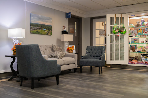 A cozy living room featuring a gray sofa, armchair, and a welcoming atmosphere.