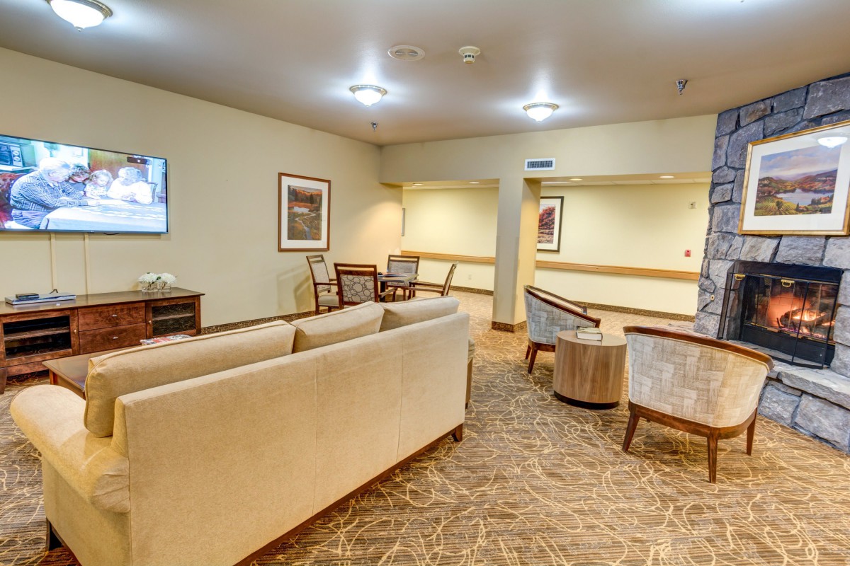 A cozy living room with comfortable seating and warm lighting.