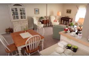 A cozy living room with a traditional dining area and comfortable seating.