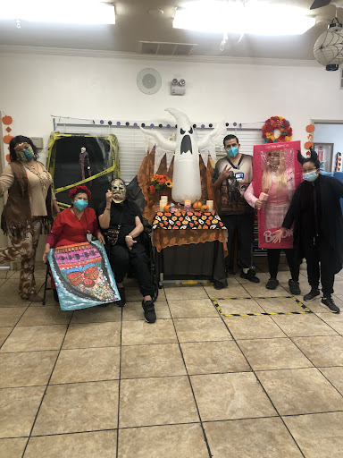 A lively group dressed in various costumes for a Halloween-themed celebration.