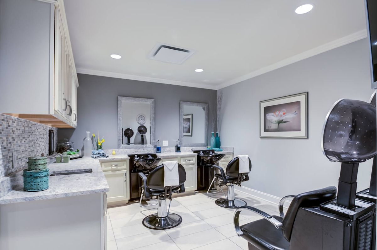 A modern salon interior with barber chairs and mirrors.
