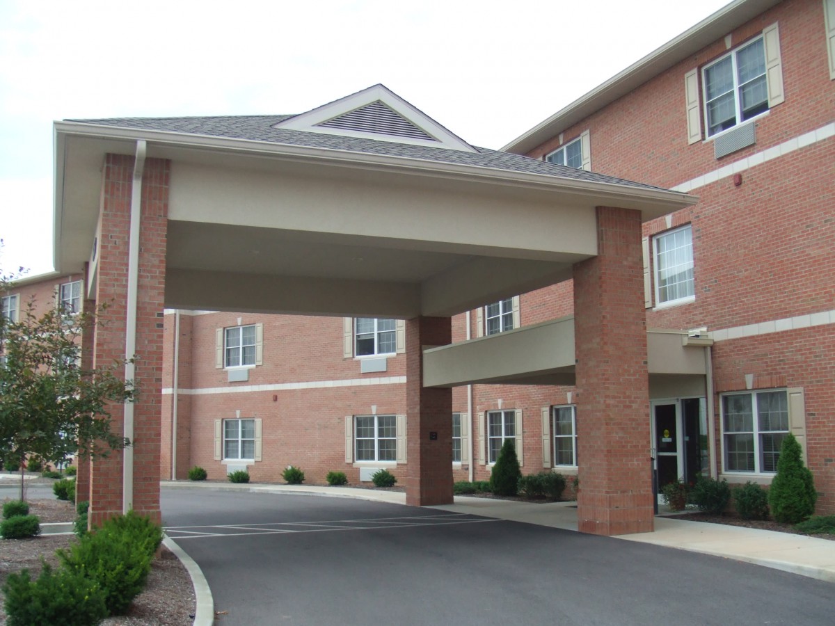 A brick building with a covered entrance.