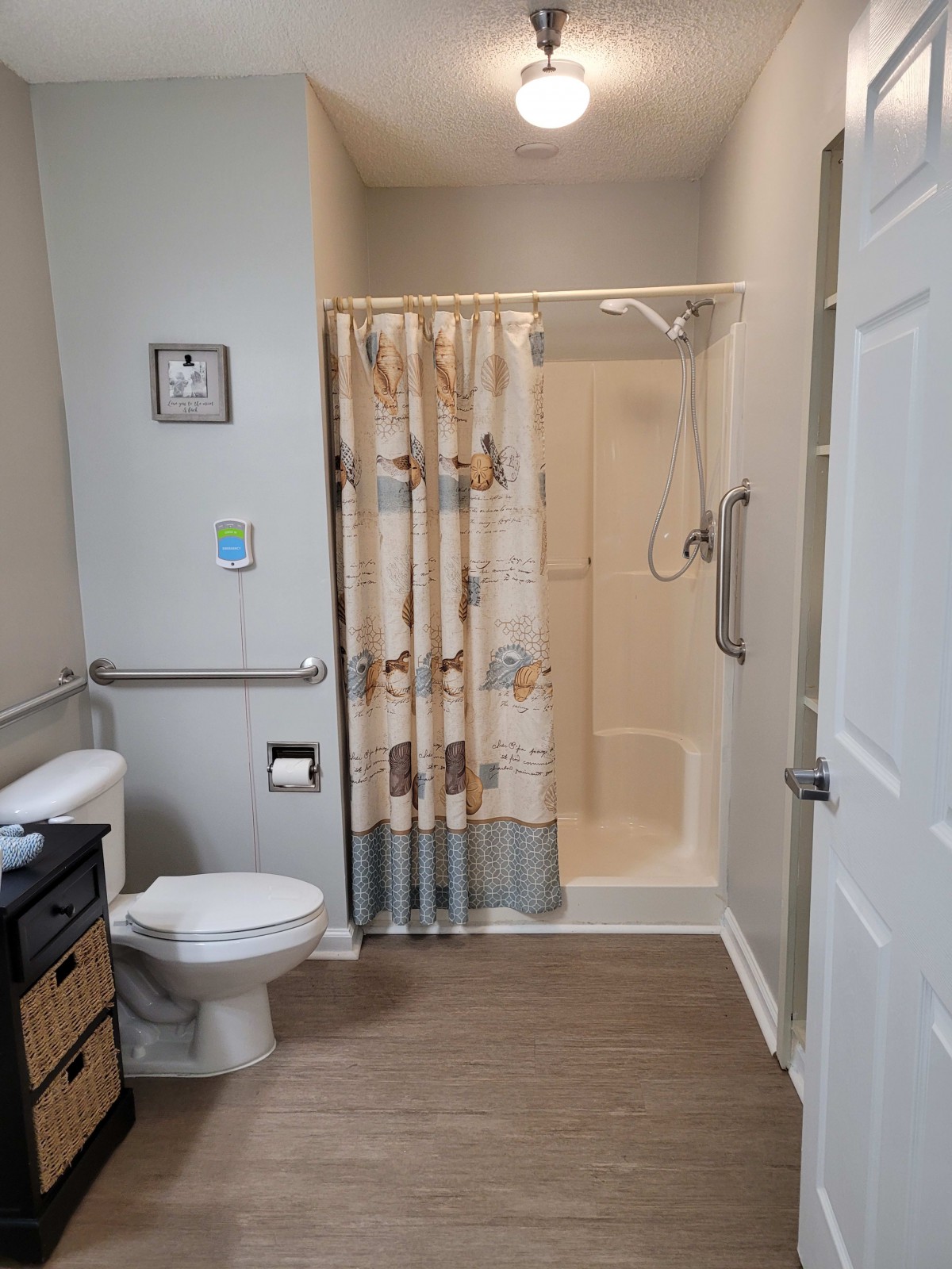 A well-organized bathroom with a shower, toilet, and accessibility features.