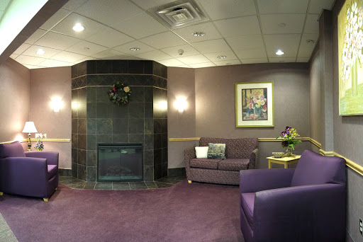 A cozy lobby area featuring a stylish purple color scheme and a welcoming fireplace.