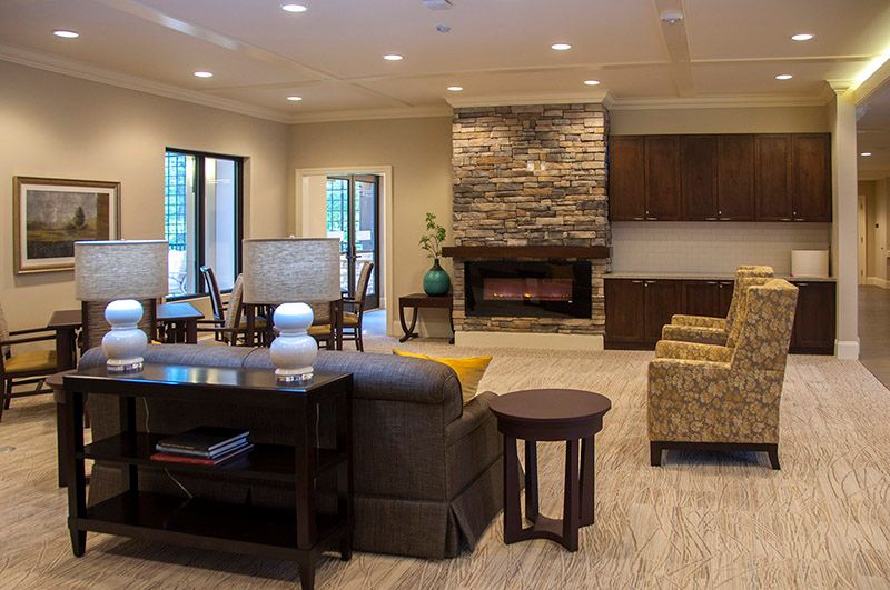 A cozy living room with modern decor and a stone fireplace.