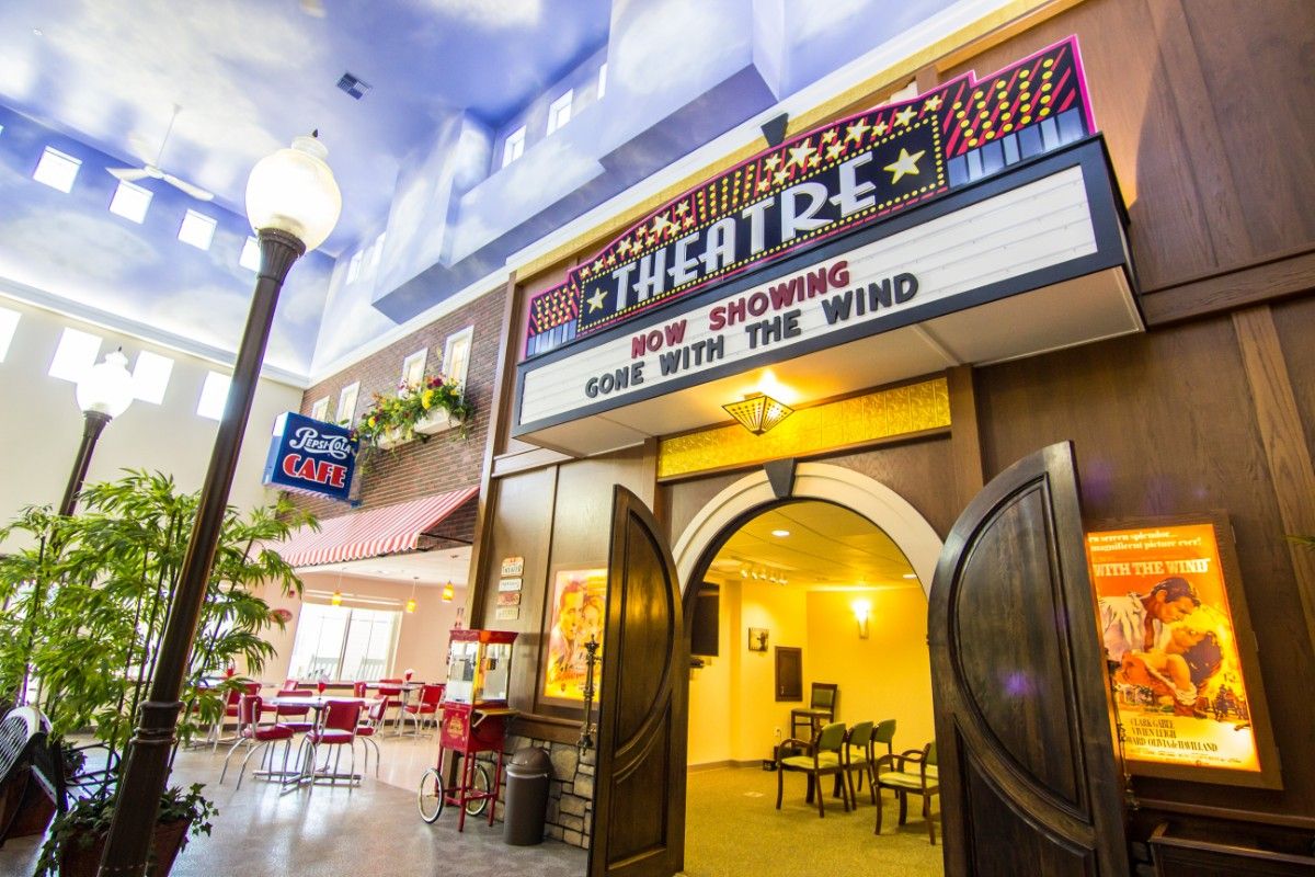 A retro-style movie theater interior with a marquee showing 'Gone with the Wind'.