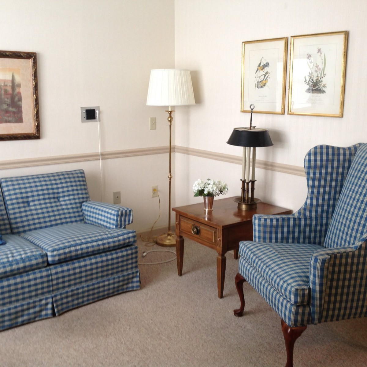 A cozy living room with blue patterned furniture and decorative elements.
