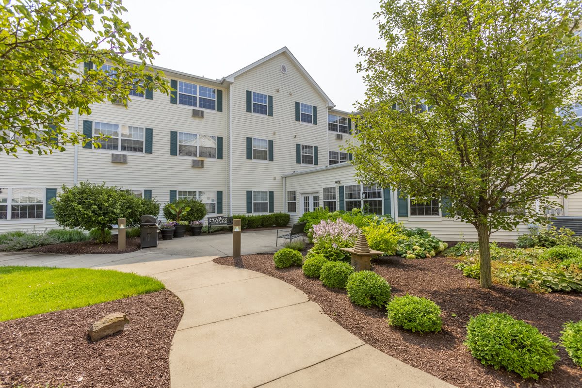 A residential building with a landscaped garden and pathway.
