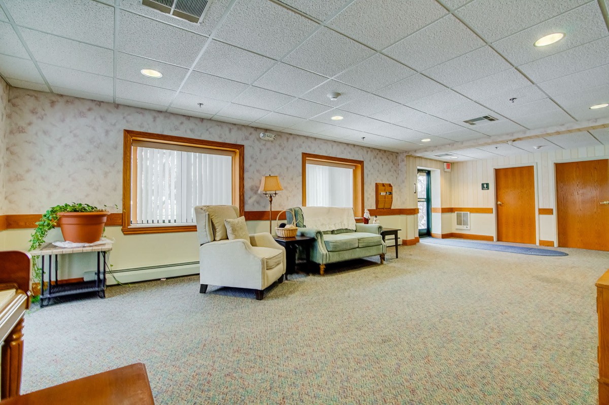A spacious lounge area with comfortable seating and ample natural light.