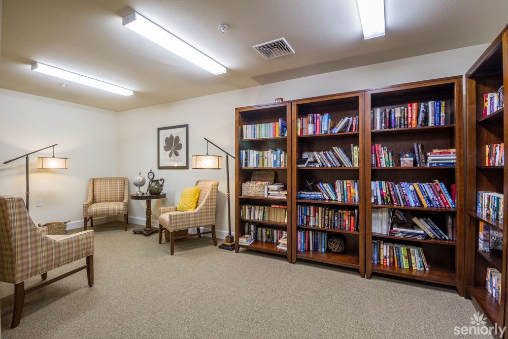 A cozy reading area with bookshelves and comfortable seating.