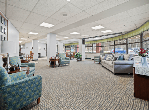 A spacious lobby area with various seating arrangements and large windows.