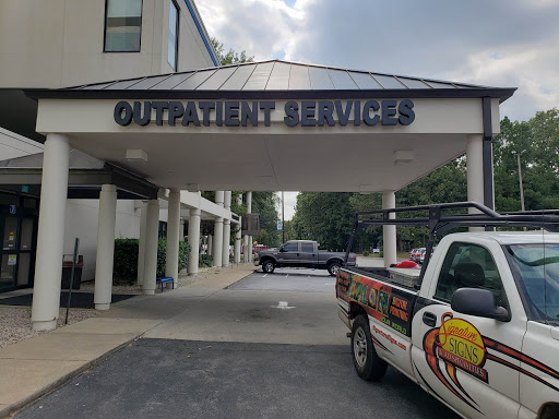 Entrance to a service building with parked vehicles.