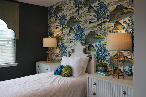 A beautifully designed bedroom featuring elegant wallpaper and stylish furnishings.