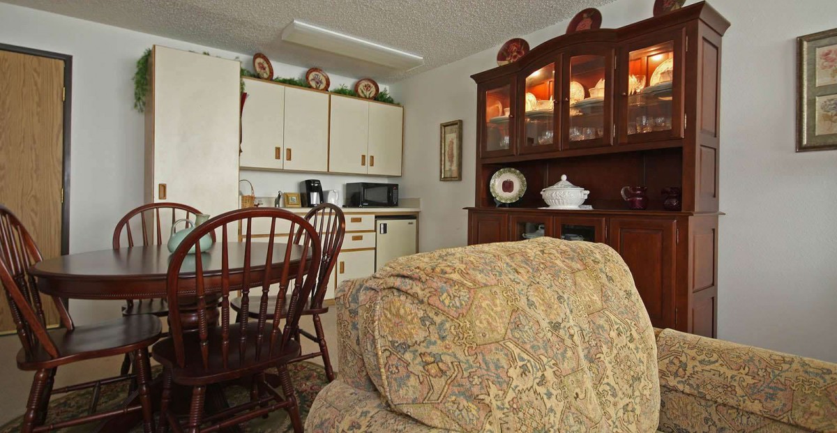 A cozy kitchen dining area with wooden furniture and decorative elements.