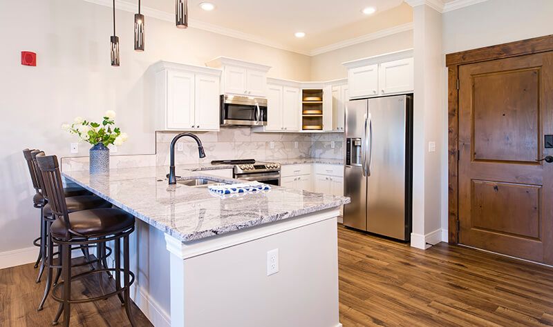 A modern kitchen with stainless steel appliances and elegant countertops.