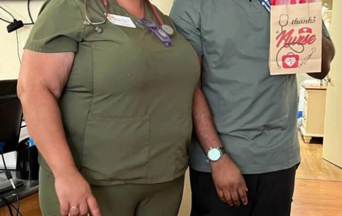 Two individuals in medical scrubs standing side by side.