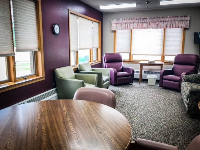 A cozy living room with comfortable chairs and ample natural light.