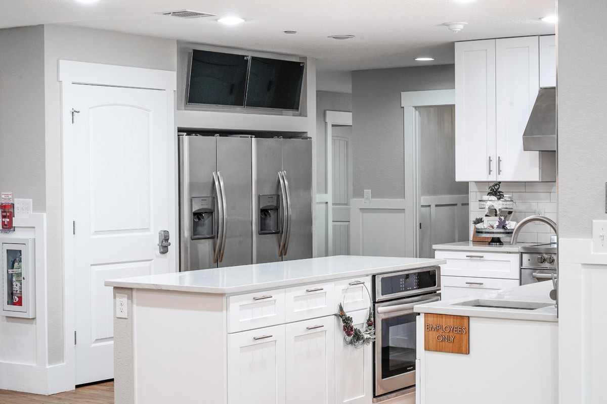 A modern kitchen with stainless steel appliances and a central island.