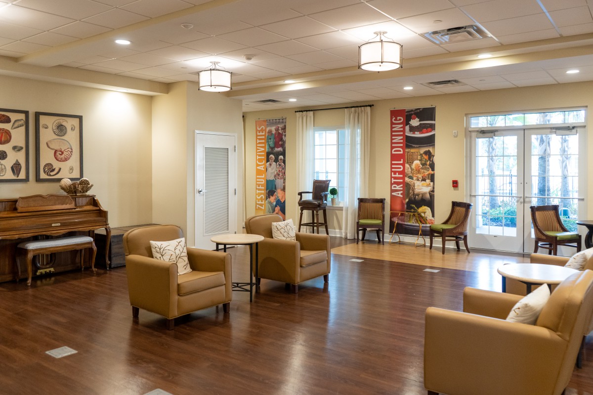 A modern lobby area with comfortable seating and wooden flooring.