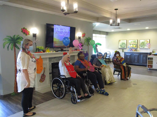 A lively gathering of senior citizens participating in a fun activity at a community center, with staff engaging and colorful decorations enhancing the festive atmosphere.