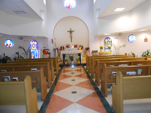 Interior view of a church showcasing the altar and seating for worshippers.
