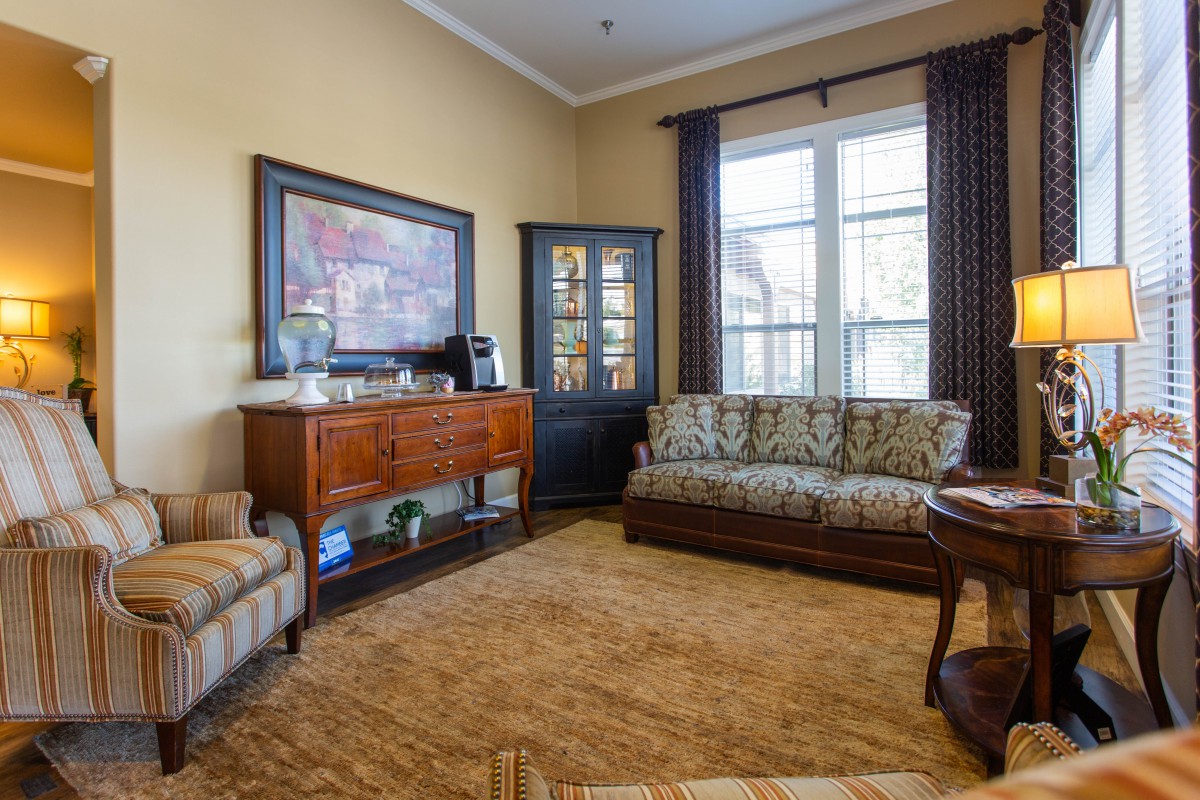 A cozy living room featuring comfortable seating and classic wooden furniture.