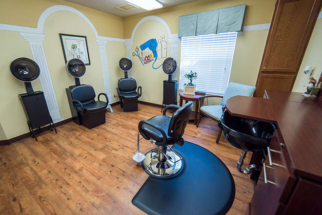 A cozy hair salon interior with seating and styling stations.