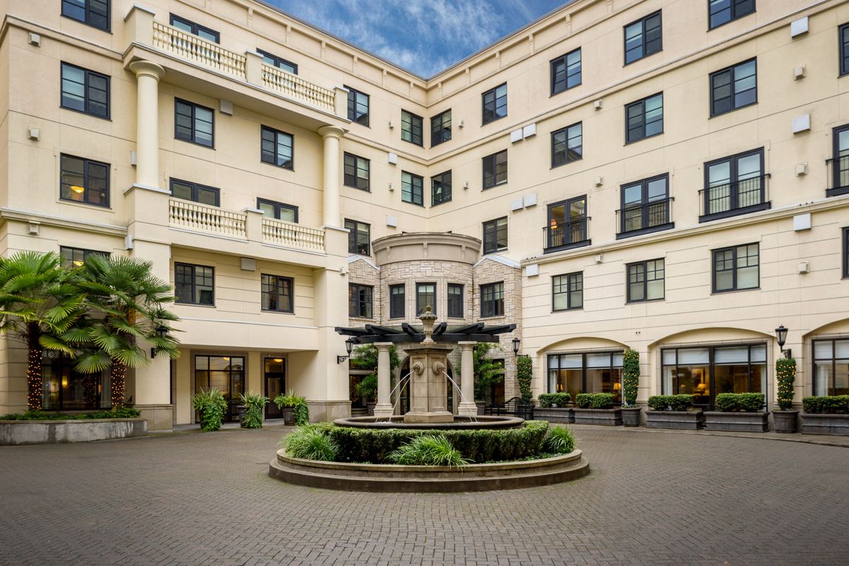 Elegant residential building with a central courtyard and fountain.