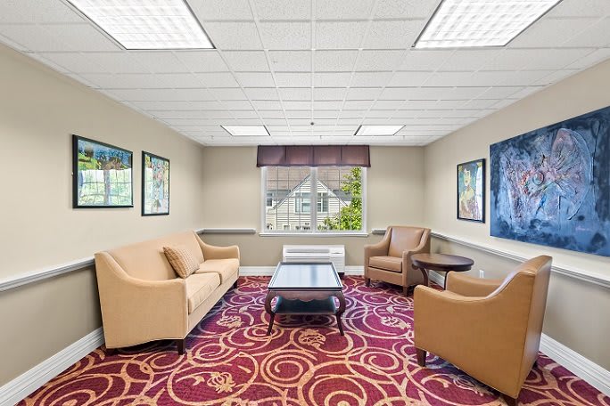 A well-lit lobby area with comfortable seating and colorful carpet.