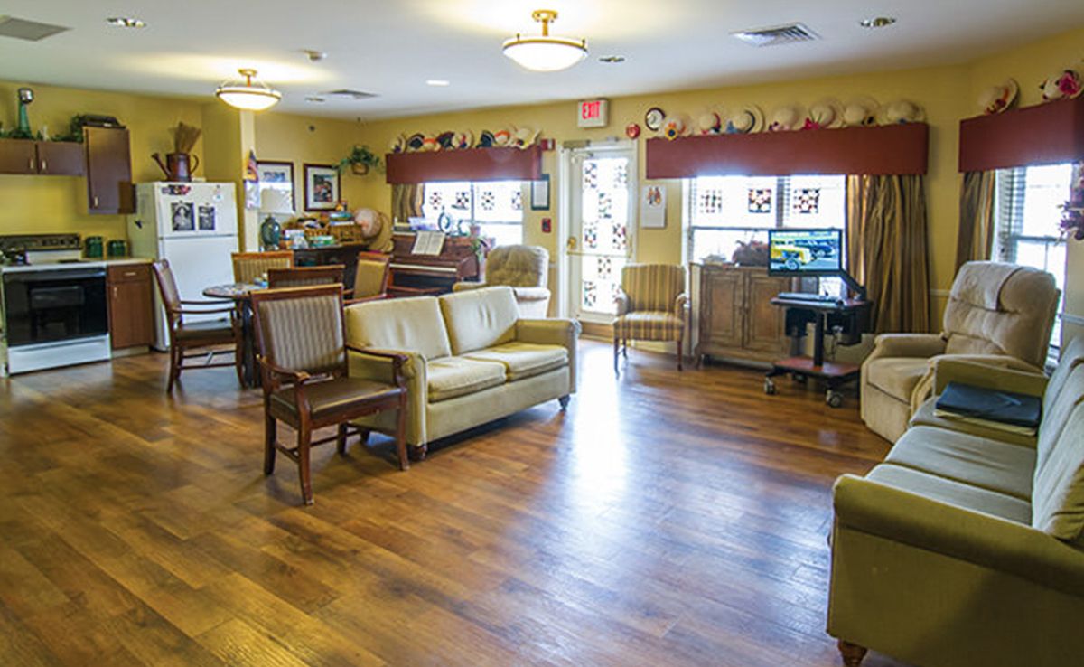 A cozy living room with comfortable seating and bright lighting.