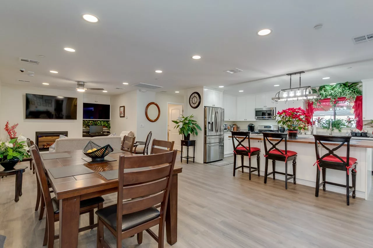 A spacious open-concept dining and kitchen area with modern decor and wooden flooring.