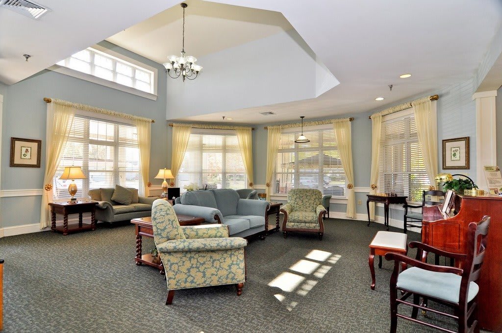 A cozy living room with various seating options and abundant natural light.