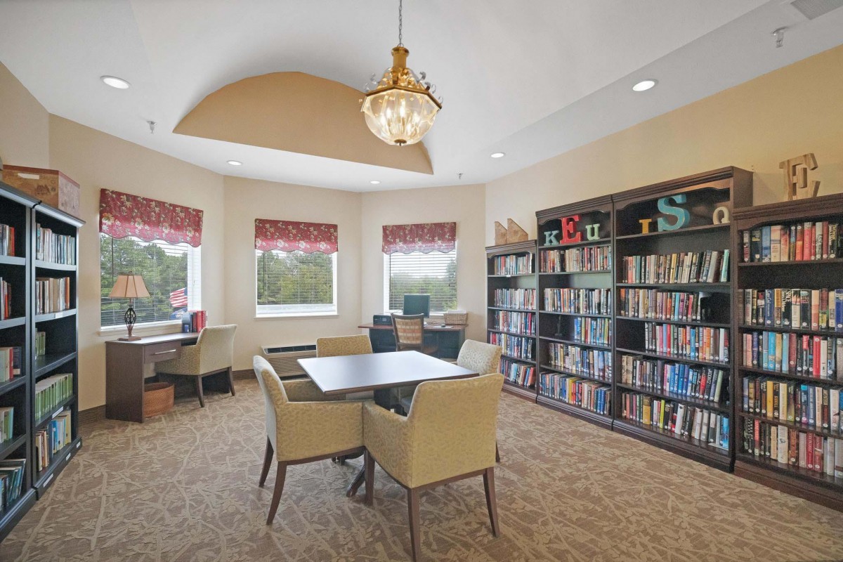 A cozy library reading area with bookshelves and seating.