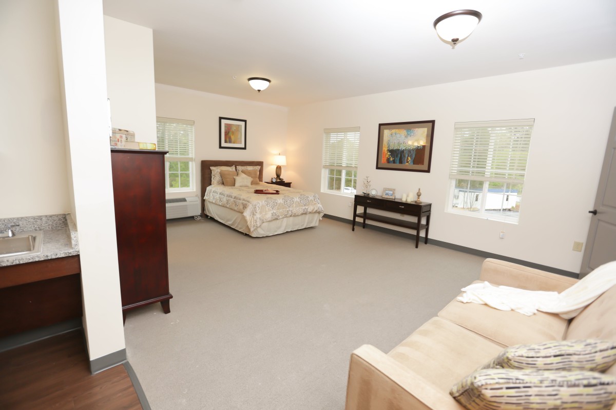 Spacious and well-lit bedroom with classic furniture and decorative art.
