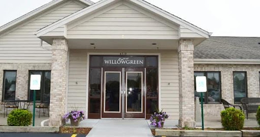 The welcoming entrance of WILLOWGREEN, adorned with beautiful flowers.