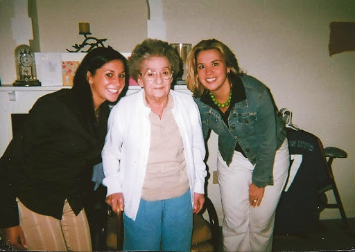 A joyful moment shared between three women, celebrating together.