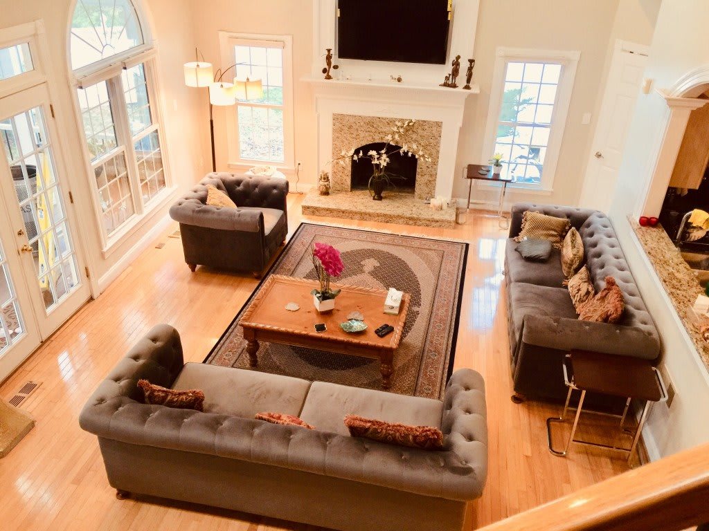 Spacious living room with elegant furniture and a fireplace.