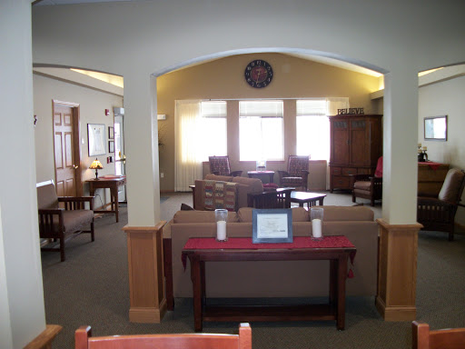 A cozy lounge area featuring comfortable seating and ample natural light.