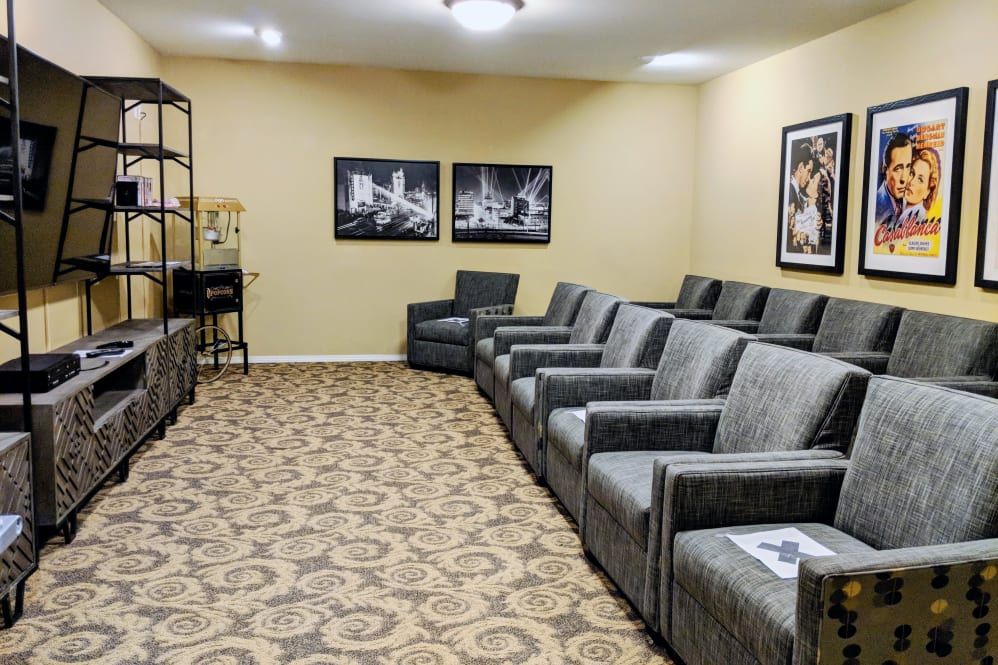 A cozy room with comfortable seating and artwork on the walls.