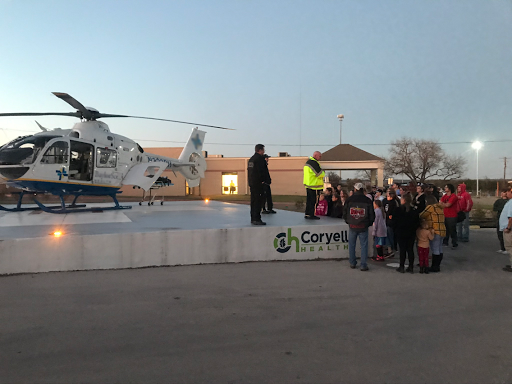 A crowd gathers to learn about emergency helicopter services during a community demonstration.
