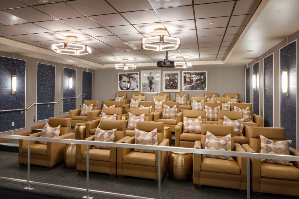 Luxurious home theater room with plush seating and elegant lighting.