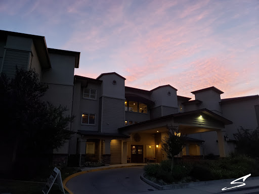 A beautifully lit building captures the serene colors of a sunset.