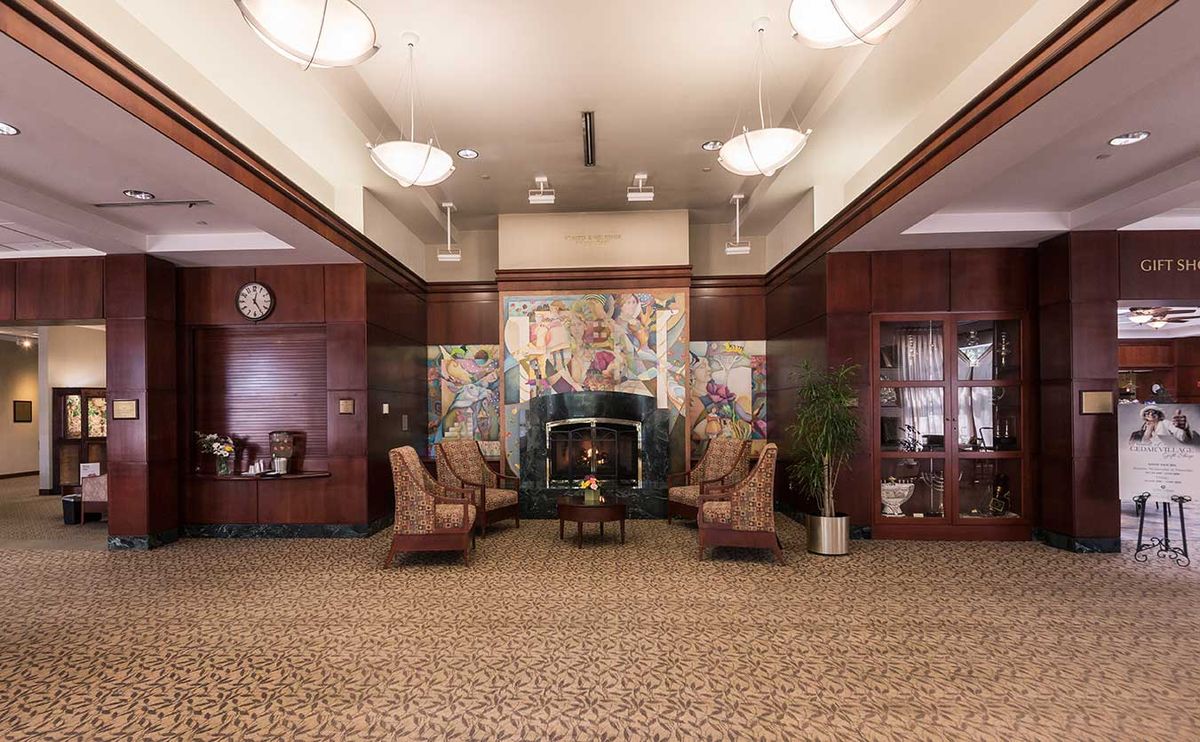 A hotel lobby with elegant seating, decorative artwork, and warm lighting.